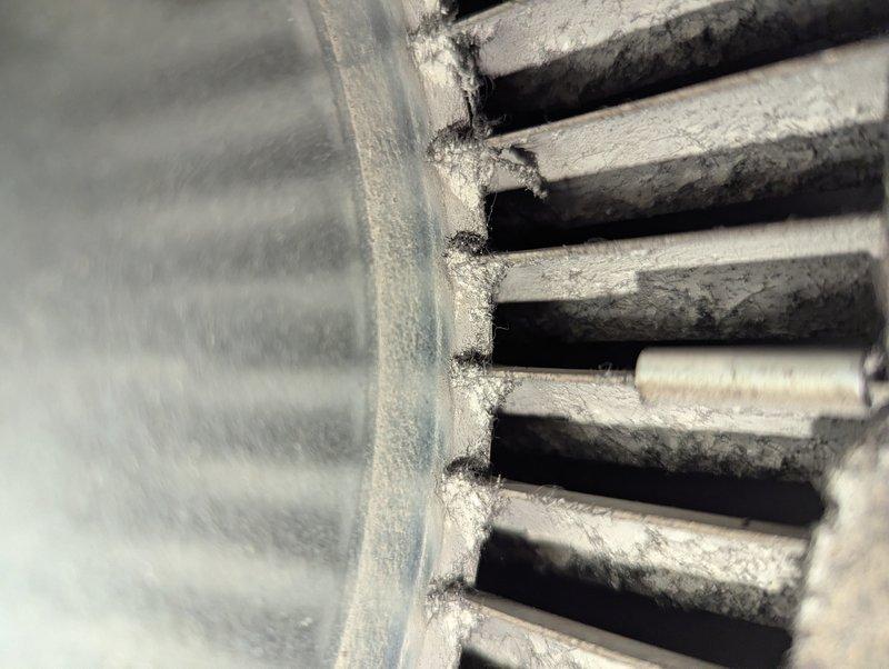 Completed annual heating maintenance on 7-year-old furnace and humidifier system. Inspected evaporative cooler pad showing moderate mineral deposits and discoloration along edges, indicating normal wear from water exposure. Examined heat exchanger fins which exhibited significant dust and debris accumulation between parallel rows, particularly at base connections. Performed standard tune-up procedures including cleaning components, checking water distribution system operation, and verifying proper airflow through honeycomb media. System operational upon completion of preventive maintenance service.