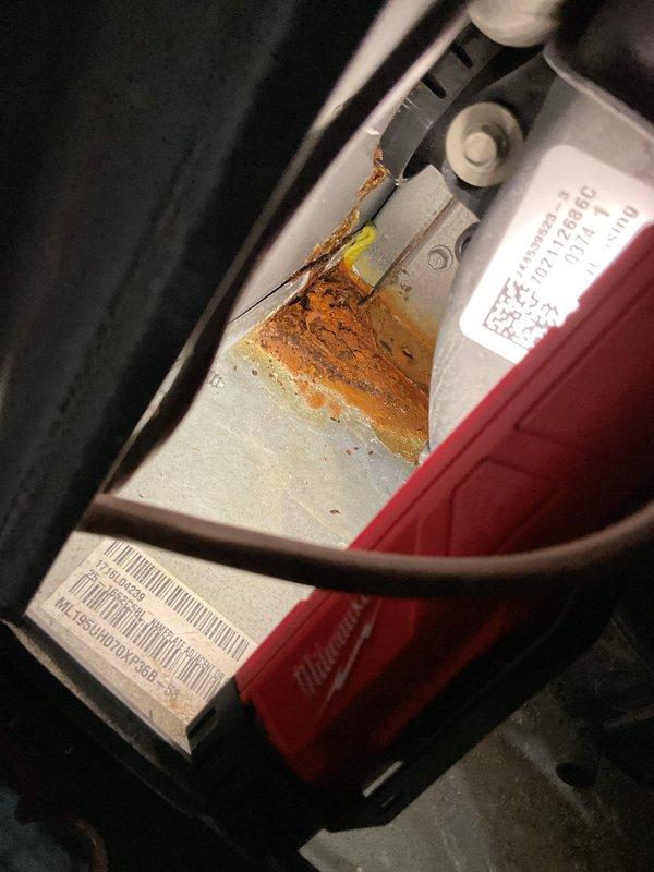 Completed annual heating tune-up on furnace system with no humidifier present. During inspection, identified significant rust and corrosion on mounting hardware and lower cabinet panels where unit meets floor, indicating moisture exposure. Documented all findings with photographs for customer records.