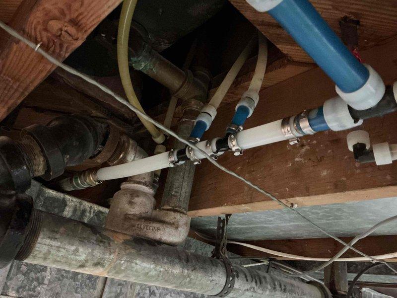 Replaced deteriorated galvanized steel piping in crawl space using Mega press 3/4" fittings with coupling and nipple. Integrated new connection with existing PEX system using female thread adapter to ensure proper water flow and prevent future corrosion issues.