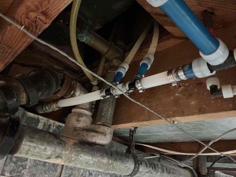 Replaced deteriorated galvanized steel piping in crawl space using Mega press 3/4" fittings with coupling and nipple. Integrated new connection with existing PEX system using female thread adapter to ensure proper water flow and prevent future corrosion issues.