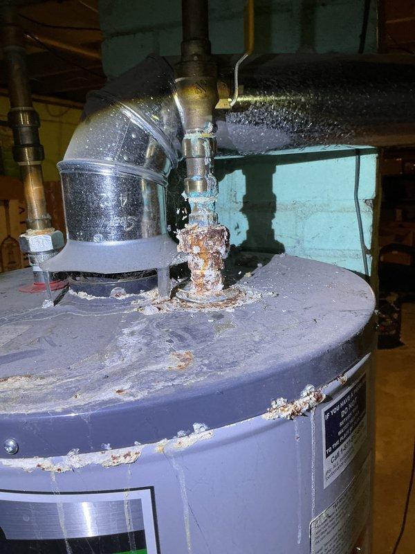 Completed annual heating maintenance and furnace tune-up on EnergiAir system with 2023 compressor. Observed condensate drainage system with dual drain pans showing active moisture collection and HVAC condensate pump operation. Additionally noted water heater in mechanical room displaying significant mineral buildup and corrosion on pressure relief valve, indicating active water leakage requiring future attention.