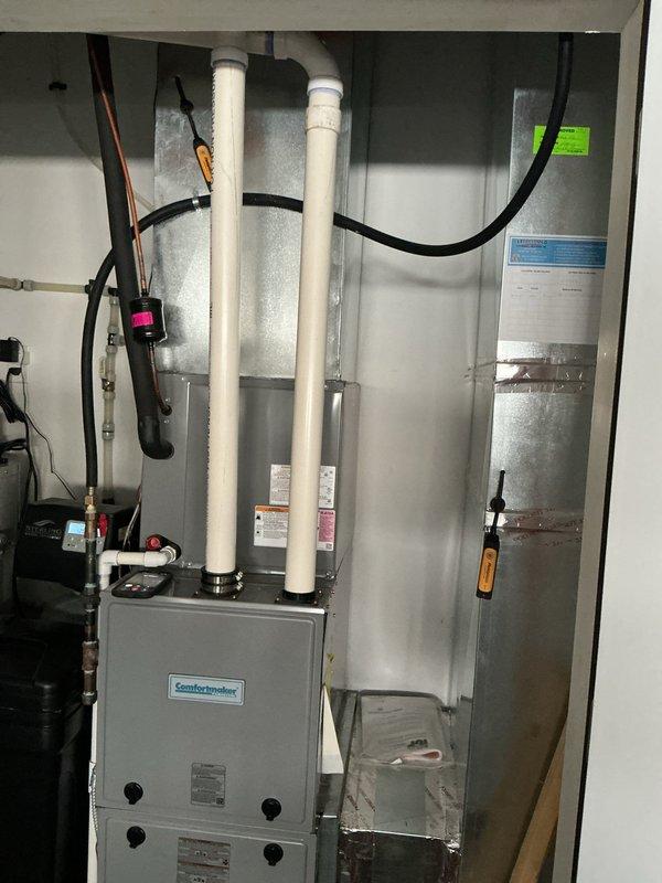 Completed annual heating maintenance on 6-year-old ICP ComfortMaker furnace system. Performed comprehensive tune-up including inspection of heat exchanger, burner assembly, and ignition system; verified proper venting through PVC intake and exhaust pipes; tested all safety controls and limit switches; checked electrical connections and amp draw on blower motor; cleaned flame sensor and confirmed proper furnace operation. System operating within manufacturer specifications with no issues found.