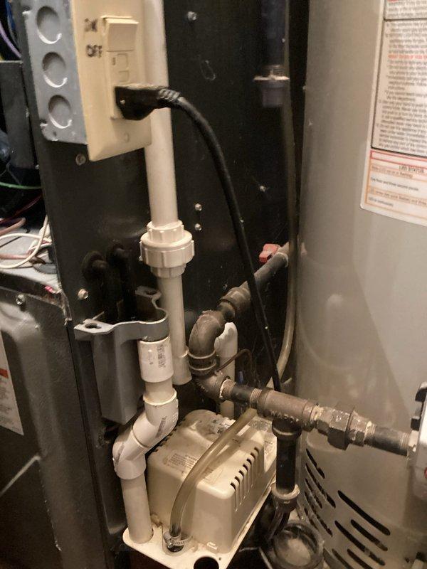 Completed annual heating and cooling maintenance on EnergiAir system (12 years old) and 2-year-old EnergiAir water heater (warranty through June 2028). Performed comprehensive tune-up on furnace and air conditioning unit. Inspected condensate drainage system including metal drain pan and condensate pump assembly with PVC piping. Verified proper operation of condensate pump and drainage pathways. Checked water heater connections, copper piping, and valves. Documented equipment condition through photos showing drainage components and mechanical utility area. All systems operating within normal parameters upon completion of annual maintenance.