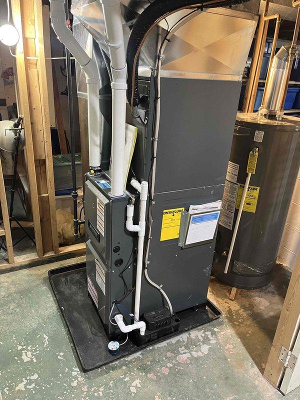 Completed full HVAC system replacement including installation of new air handler unit in mechanical room and outdoor condensing unit. Air handler was positioned on protective mat with proper PVC condensate drainage lines routed to floor drain, and new outdoor condenser was mounted on concrete pad against exterior wall with electrical conduit properly secured to building. All refrigerant lines were connected, system was pressurized and leak tested, electrical connections were verified, and unit was successfully started up and tested for proper operation across all heating and cooling modes.