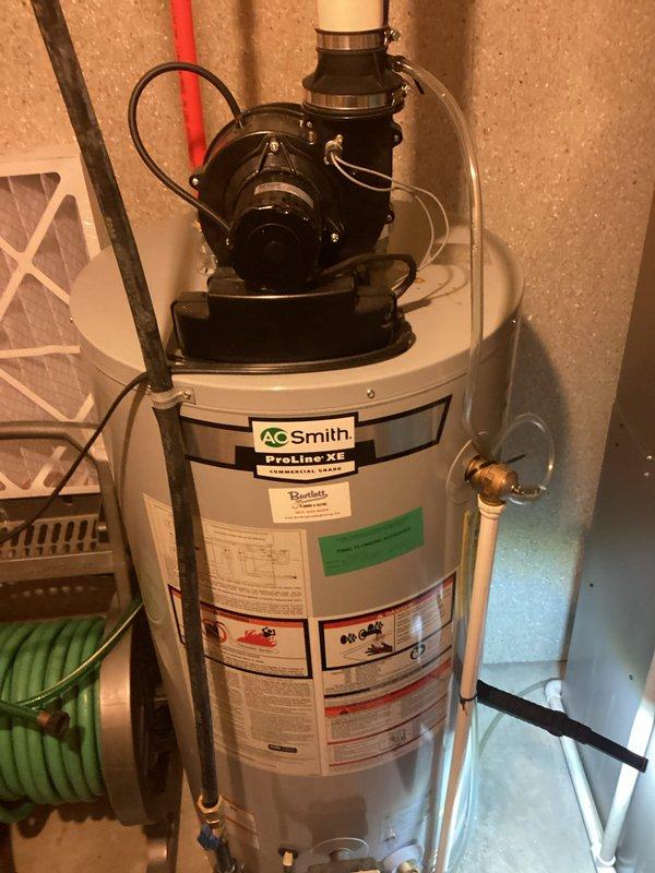 Provided estimate for water heater replacement on existing A.O. Smith ProLine XE unit located in basement utility area. Documented current installation including circulation pump assembly, PEX piping configuration with red and blue supply lines, brass valve connections, and copper fittings for customer review and approval.