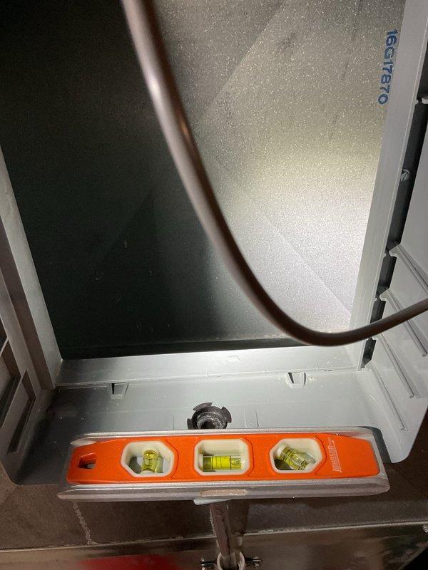 Responded to water leak issue beneath furnace unit. Upon inspection, found Generac HVAC unit experiencing water accumulation at base while system remained operational. Verified unit levelness using precision level tool and inspected interior ductwork chamber for moisture intrusion points. Documented condensate drainage pathway and checked for proper pitch on drain lines. Unit confirmed to be maintaining heating function despite water presence. Photographed equipment positioning, drain components, and interior plenum condition for service records.