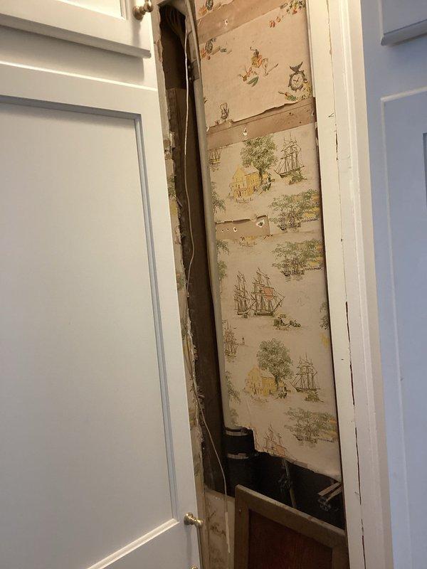 Completed partial drain repipe replacement as quoted. Accessed existing vertical drainage system through interior wall cavity, requiring removal of wall covering material to expose plumbing infrastructure. Replaced deteriorated drain piping with new white PVC drainage pipe, securing installation with proper mounting brackets at code-compliant intervals along vertical run. Pipe extends from upper floor drainage connection down through wall cavity to lower level tie-in point. All connections properly fitted and secured. Work performed in occupied residence with minimal disruption to living space. Installation meets current plumbing code requirements for residential drainage systems.