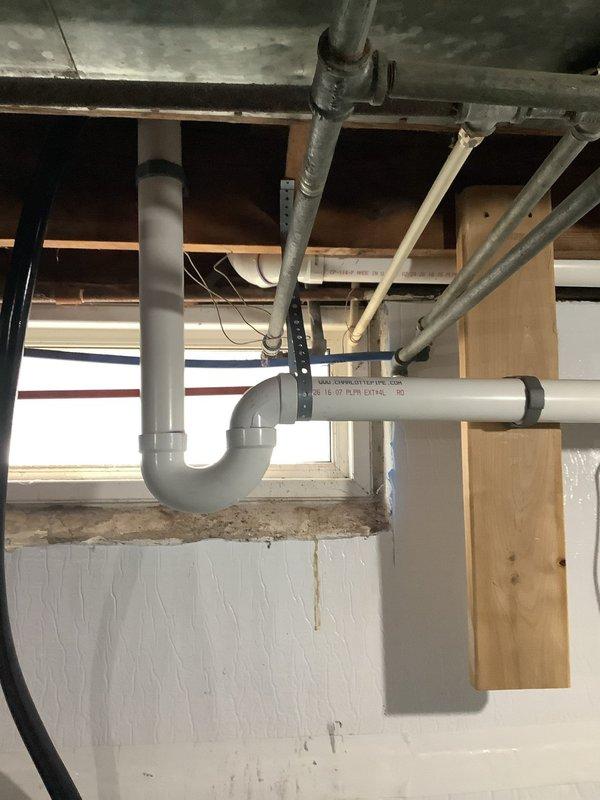 Completed repipe of laundry and kitchen sink drain lines in basement area. Installed new PVC drain piping with proper P-trap assembly and horizontal waste lines, secured to floor joists with appropriate hangers and supports. All connections made to code specifications with proper slope for drainage, ensuring reliable waste water removal from both fixtures.