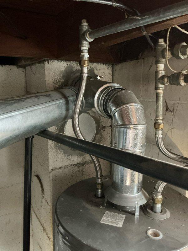 Completed comprehensive water heater replacement estimate for residential property. Assessed existing water heater installation in unfinished basement, documenting current configuration including galvanized steel piping, flexible braided stainless steel connectors, aluminum vent pipe system, and standard plumbing connections. Photographed equipment layout and utility room conditions to provide accurate replacement specifications and pricing options.