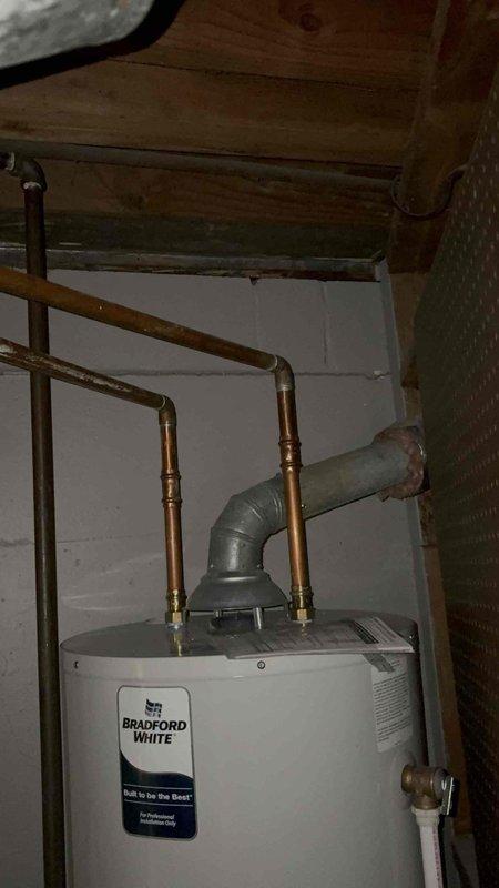 Provided estimate for direct vent water heater replacement in basement utility area. Assessed existing Bradford White water heater installation, copper plumbing connections, and PVC venting configuration to determine proper equipment specifications and installation requirements for direct vent system.