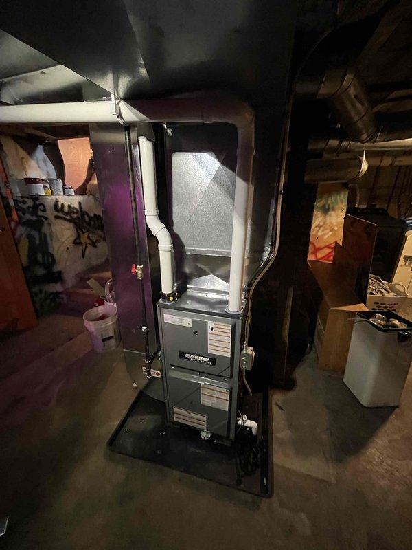 Completed full furnace installation in residential basement location. Installed new furnace unit on protective base pad with proper venting through white PVC piping, connected to existing ductwork system, and verified all connections for safe operation. System tested and left operational upon completion.