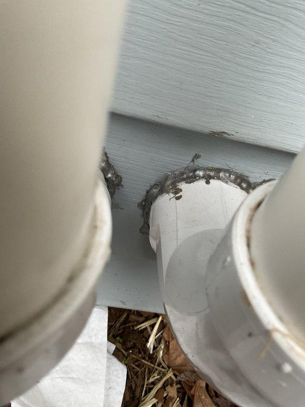 Completed annual heating maintenance on EnergiAir furnace system without humidifier. Performed comprehensive tune-up including filter inspection, burner assembly cleaning, heat exchanger examination, blower motor lubrication, and combustion analysis to ensure proper operation and efficiency. Documented exterior penetrations showing PVC intake and exhaust venting with deteriorated sealant and debris accumulation requiring attention, as well as soffit area with organic material buildup around pipe penetrations that may impact system performance if not addressed.