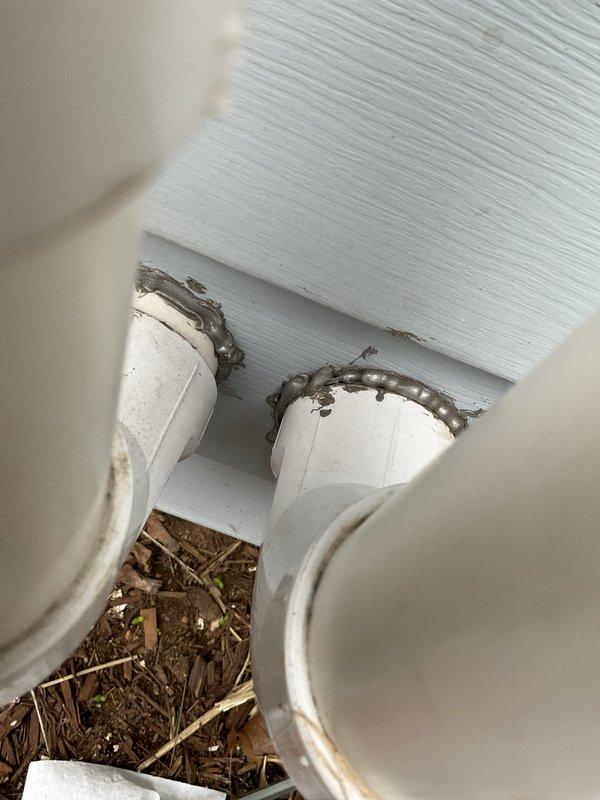 Completed annual heating maintenance on EnergiAir furnace system without humidifier. Performed comprehensive tune-up including filter inspection, burner assembly cleaning, heat exchanger examination, blower motor lubrication, and combustion analysis to ensure proper operation and efficiency. Documented exterior penetrations showing PVC intake and exhaust venting with deteriorated sealant and debris accumulation requiring attention, as well as soffit area with organic material buildup around pipe penetrations that may impact system performance if not addressed.
