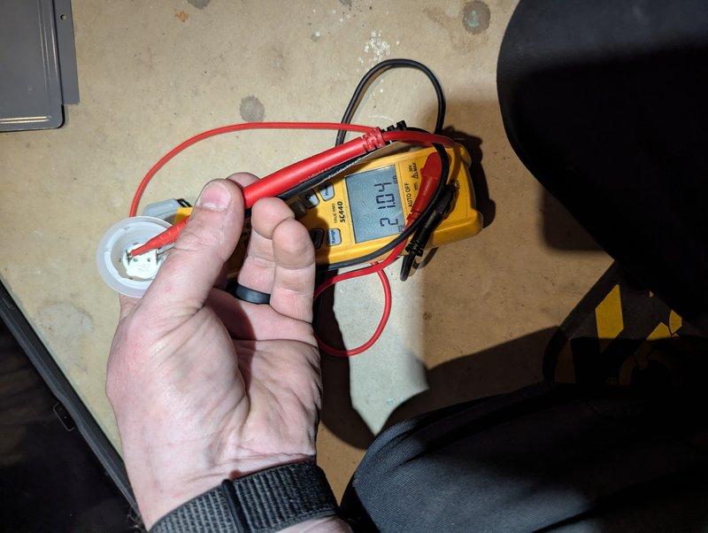 Responded to 9-year-old Rheem water heater displaying 7-blink error code after recent repair. Performed diagnostic testing using multimeter to measure voltage at heating element (701.2V reading) and tested capacitor functionality (28.13 reading). Error code indicated thermal cutoff or high limit switch fault, requiring component testing to isolate the issue and restore proper heating operation.