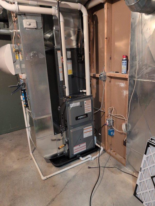 Completed full system installation including new furnace, air conditioning unit, and water heater in basement mechanical room. Installed furnace on raised platform with proper intake and exhaust venting, connected air handler with PVC condensate drainage, and routed all necessary ductwork. Installed water heater with copper supply lines, brass fittings, and proper venting, along with AprilAire humidifier integrated into HVAC system with water supply connection. All equipment properly wired, tested for operation, and left in working condition per manufacturer specifications.