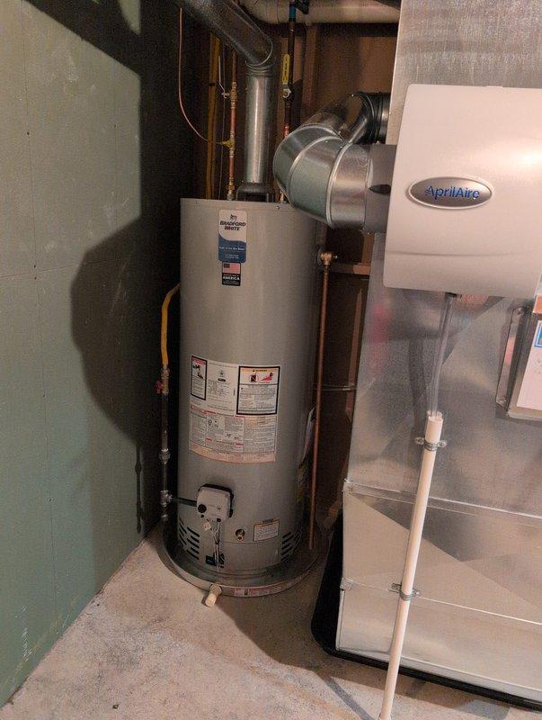 Completed full system installation including new furnace, air conditioning unit, and water heater in basement mechanical room. Installed furnace on raised platform with proper intake and exhaust venting, connected air handler with PVC condensate drainage, and routed all necessary ductwork. Installed water heater with copper supply lines, brass fittings, and proper venting, along with AprilAire humidifier integrated into HVAC system with water supply connection. All equipment properly wired, tested for operation, and left in working condition per manufacturer specifications.