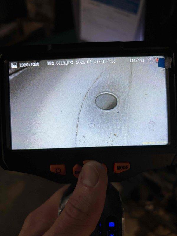 Completed annual heating maintenance on two 12-year-old Trane furnaces. Performed comprehensive tune-up procedures on both units including filter inspection, blower assembly cleaning, burner examination, and heat exchanger inspection using borescope camera. Visual inspection revealed crack in heat exchanger of one unit, which poses potential safety hazard for carbon monoxide leakage. Documented findings with detailed photographs showing compromised heat exchanger integrity. Recommended immediate unit replacement due to failed heat exchanger. Second furnace passed all safety checks and operational testing without issues.