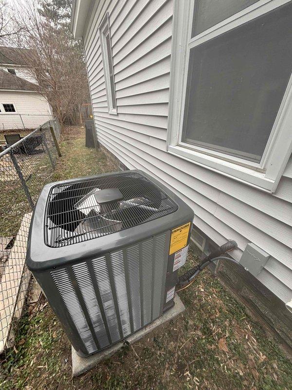 Completed full HVAC system installation including Goodman furnace and air handler in basement utility area, along with outdoor condensing unit positioned on concrete pad against exterior wall. Installed white PVC condensate drain lines, connected refrigerant lines, and verified all electrical connections with proper clearances for maintenance access. System tested and operational upon completion.