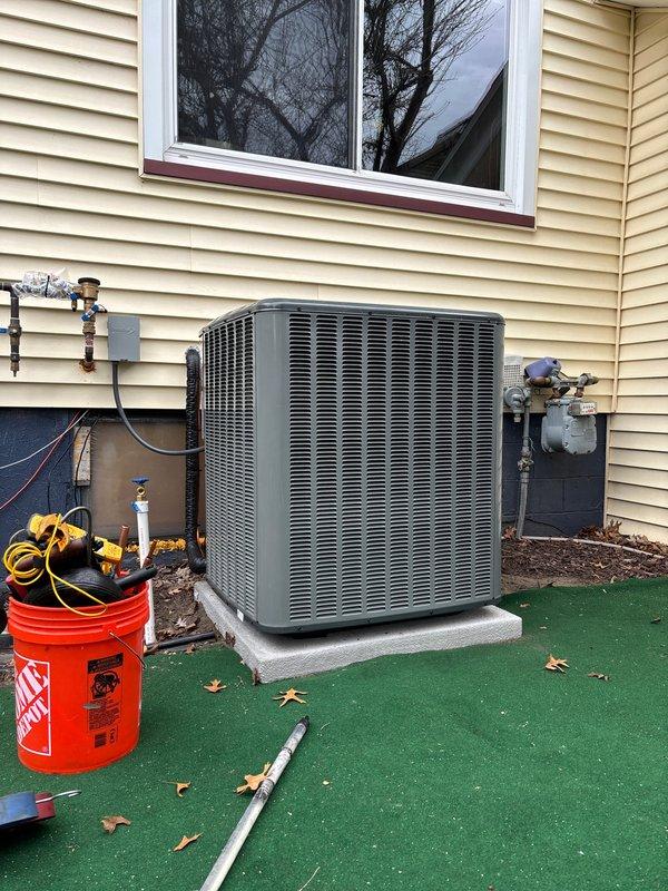 Completed full system replacement of residential furnace and air conditioning unit. Installed new outdoor condensing unit on existing concrete pad with proper refrigerant line connections, electrical disconnect, and service valves. Ran copper refrigerant lines with insulation along exterior wall, established all electrical connections, and verified proper system operation. Unit secured on pad with artificial turf base protection, all service valves capped and accessible for future maintenance.