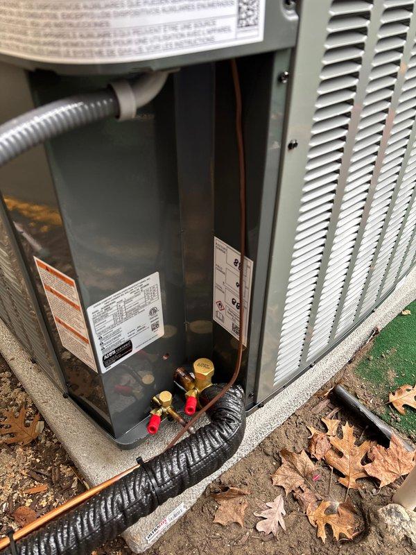Completed full system replacement of residential furnace and air conditioning unit. Installed new outdoor condensing unit on existing concrete pad with proper refrigerant line connections, electrical disconnect, and service valves. Ran copper refrigerant lines with insulation along exterior wall, established all electrical connections, and verified proper system operation. Unit secured on pad with artificial turf base protection, all service valves capped and accessible for future maintenance.