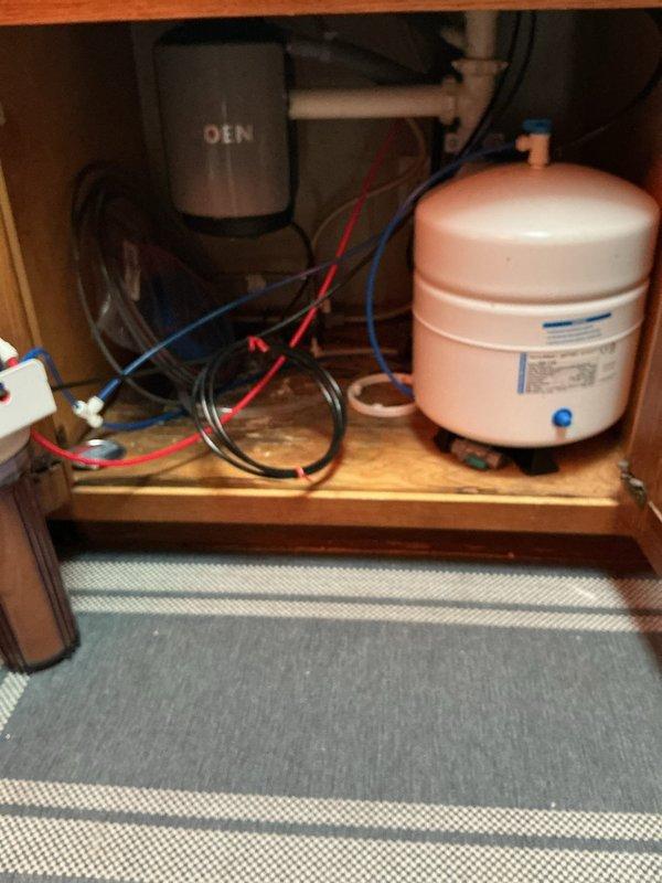 Completed installation of new kitchen sink, faucet, and garbage disposal unit. Addressed and repaired existing water damage found in cabinet base beneath sink, ensuring all plumbing connections were properly sealed and functional upon completion.