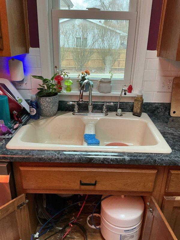 Completed installation of new kitchen sink, faucet, and garbage disposal unit. Addressed and repaired existing water damage found in cabinet base beneath sink, ensuring all plumbing connections were properly sealed and functional upon completion.