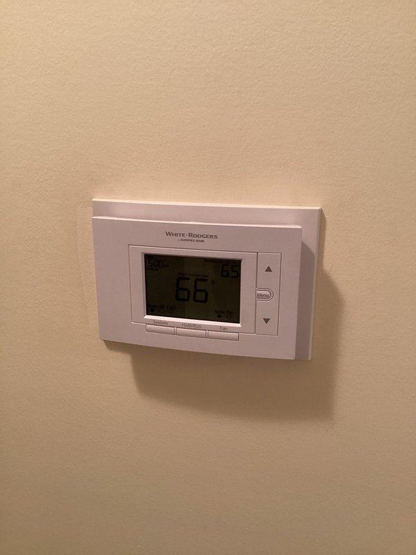 Completed QUOTR-quoted repair involving zone panel thermostat service and exhaust pipe insulation replacement. Installed White-Rodgers digital thermostat on zone system and rewrapped exhaust piping with black foam insulation. Verified proper operation of HZ311 zone control module with Aprilaire humidistat integration across all three heating zones.