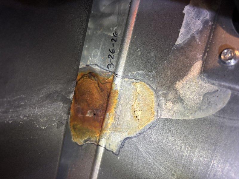 Completed annual heating maintenance on 6-year-old EnergiAir furnace with warranty valid through December 2029. Performed comprehensive tune-up including inspection of all major components, burner assembly, heat exchanger, blower motor, and electrical connections. Documented significant rust and corrosion present on cylindrical blower motor housing and adjacent pipe connections, indicating moisture exposure over time. Noted oxidation affecting metal surfaces at junction points with brownish-orange discoloration and surface degradation. Verified system operational functionality and captured photographic documentation of equipment condition for service records. No humidifier present on system.