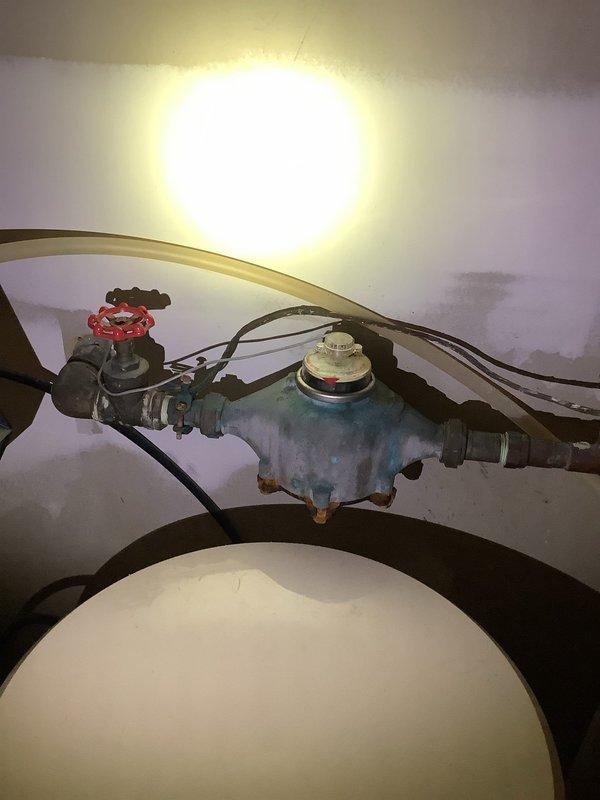 Responded to plumbing leak in 26-year-old residential property and evaluated request for water softener installation. Located and repaired leaking pipe at existing plumbing connections near water heater area. Inspected existing water heater installation, copper supply lines, and shutoff valves for compatibility with proposed water softener system. Documented current plumbing configuration including oxidized copper piping, gate valve assembly, and available connection points for future water treatment equipment integration.