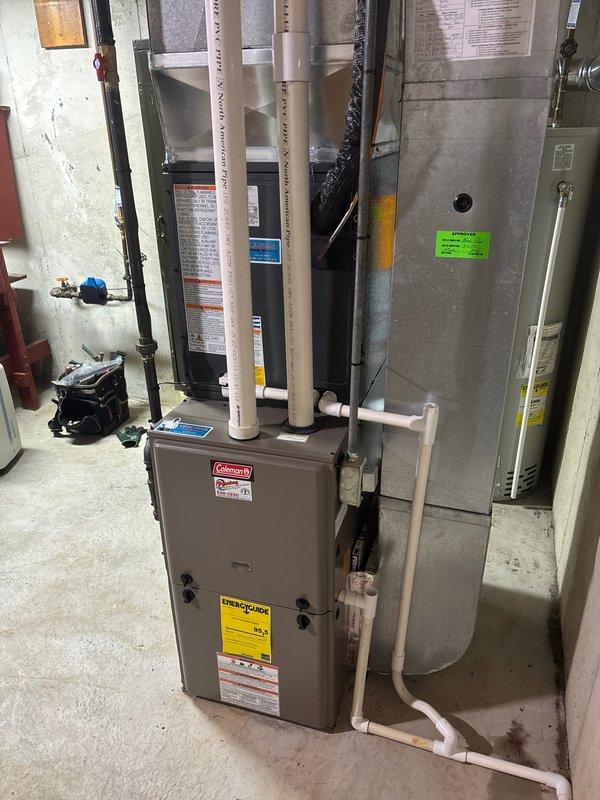 Completed full HVAC system installation in residential basement mechanical room, including Coleman furnace unit, air handler with ductwork integration, and associated components. Installed all necessary piping systems including white PVC condensate drain lines, gas line with shut-off valve, and copper fittings for proper system operation. All equipment mounted, connected, and labeled per manufacturer specifications with proper clearances maintained for service access.