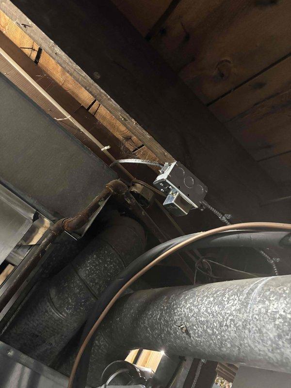 Completed full residential furnace installation featuring a new Carrier brand heating unit in basement utility area. System includes comprehensive ductwork routing with metallic segmented construction, multiple elbow joints, and proper ventilation connections to distribute conditioned air throughout the residence. All electrical connections, wiring, and mechanical components installed to manufacturer specifications and code requirements. Unit positioned on concrete floor with complete duct network integrated into existing infrastructure. System tested, activated, and confirmed operational.