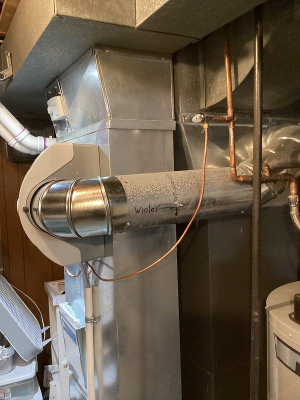 Completed annual heating maintenance on EnergiAir furnace and AprilAire humidifier system. Performed comprehensive tune-up including inspection of furnace components, ductwork with seasonal damper control, and copper refrigerant lines. Verified humidifier operation, control settings, and water supply connections with brass valves functioning properly. All equipment found in good working condition with standard residential installation throughout mechanical room.