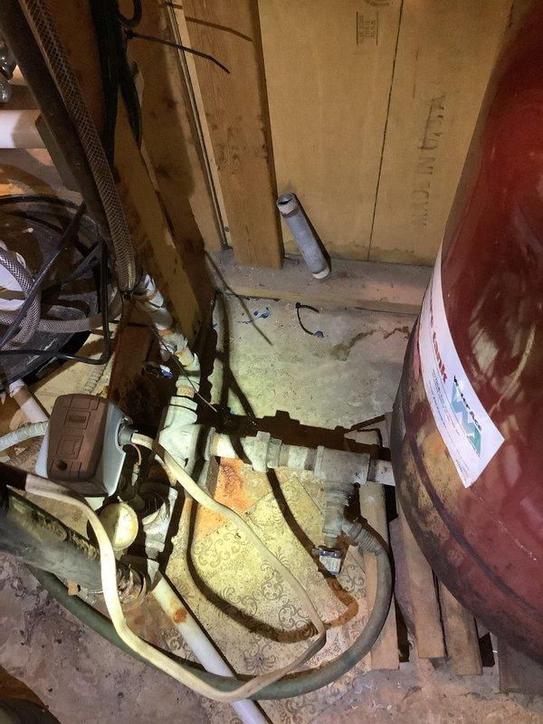 Responded to follow-up service call for ongoing low water pressure issue from private well system. Performed comprehensive inspection of well pump, pressure tank, and associated plumbing components in basement utility area, noting significant corrosion on metal piping and aging infrastructure. Confirmed findings from previous visit and reiterated recommendation that a licensed well company be contacted to diagnose and resolve the source issue, as the problem originates with the well system itself rather than the home's internal plumbing.
