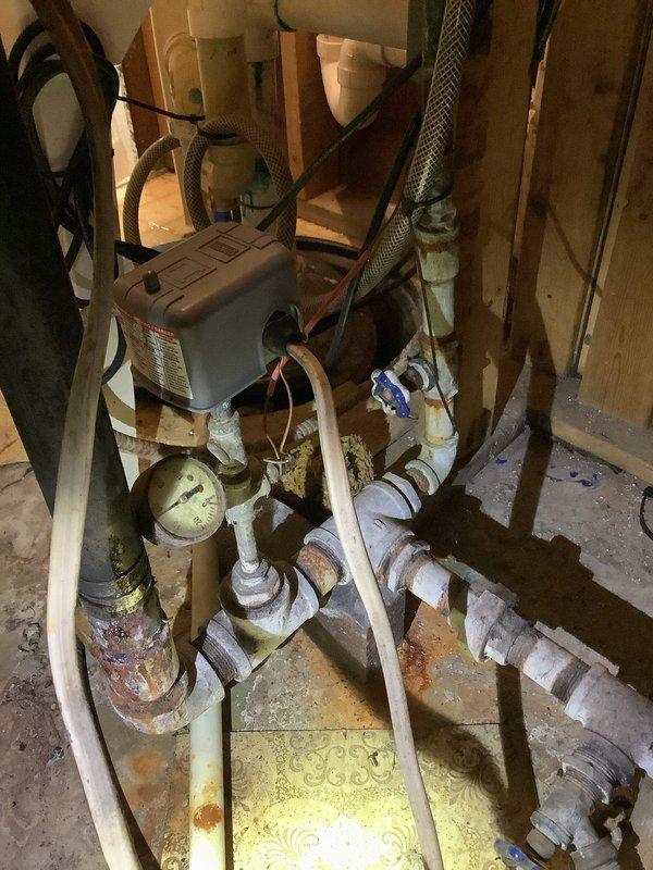 Responded to follow-up service call for ongoing low water pressure issue from private well system. Performed comprehensive inspection of well pump, pressure tank, and associated plumbing components in basement utility area, noting significant corrosion on metal piping and aging infrastructure. Confirmed findings from previous visit and reiterated recommendation that a licensed well company be contacted to diagnose and resolve the source issue, as the problem originates with the well system itself rather than the home's internal plumbing.