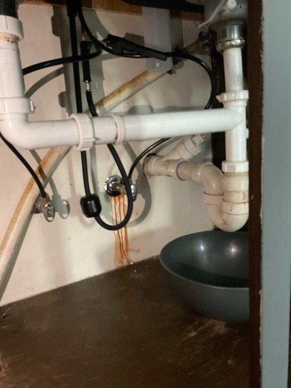 Responded to plumbing leak at kitchen sink where the tailpiece connection to the drain assembly was missing, causing the drain pipe to be improperly positioned and susceptible to disconnection. Previous installation had the pipe forced into place without proper fittings. Issue was exacerbated when dishwasher installation disturbed the makeshift connection, resulting in active leak during sink use. Installed proper slip-joint fittings and tailpiece extensions to create secure connection between sink drain and P-trap assembly, ensuring watertight seal and proper drainage function.

Additionally addressed bathroom shower diverter malfunction where water flow was splitting between showerhead and tub spout simultaneously, reducing water pressure at showerhead. Diagnosed failed diverter valve mechanism within the shower valve body. Repaired diverter component to restore proper flow direction, eliminating spout leak and restoring full water pressure to showerhead. Tested both repairs under fu