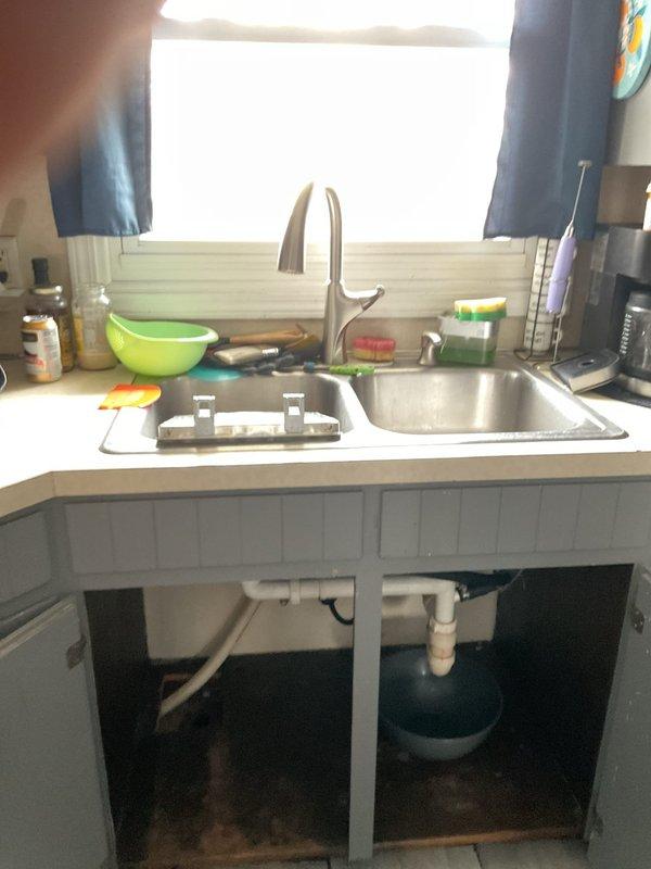 Responded to plumbing leak at kitchen sink where the tailpiece connection to the drain assembly was missing, causing the drain pipe to be improperly positioned and susceptible to disconnection. Previous installation had the pipe forced into place without proper fittings. Issue was exacerbated when dishwasher installation disturbed the makeshift connection, resulting in active leak during sink use. Installed proper slip-joint fittings and tailpiece extensions to create secure connection between sink drain and P-trap assembly, ensuring watertight seal and proper drainage function.

Additionally addressed bathroom shower diverter malfunction where water flow was splitting between showerhead and tub spout simultaneously, reducing water pressure at showerhead. Diagnosed failed diverter valve mechanism within the shower valve body. Repaired diverter component to restore proper flow direction, eliminating spout leak and restoring full water pressure to showerhead. Tested both repairs under fu