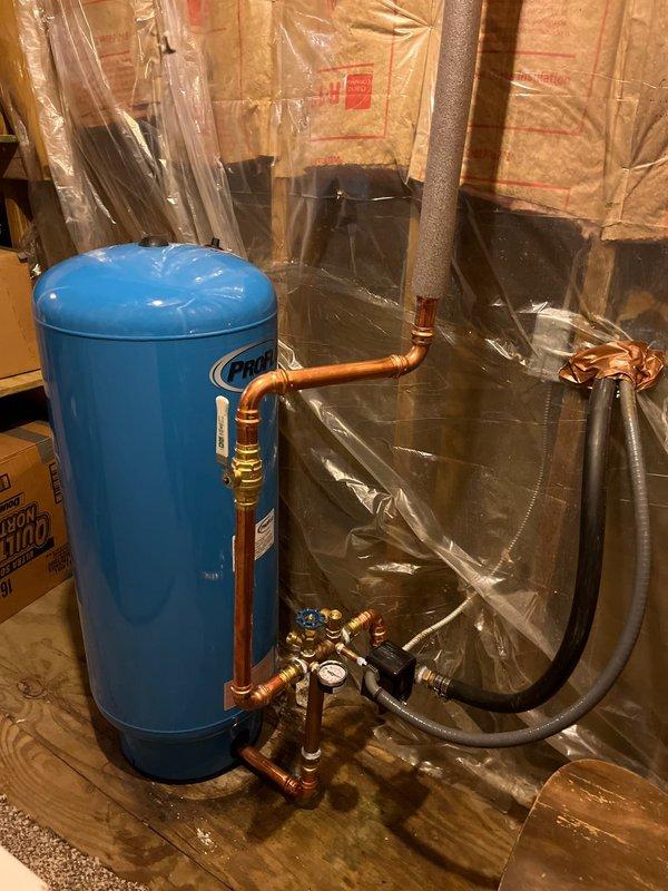 Completed full-day plumbing project installation including replacement of water pressure tank with new unit, complete with pressure switch, tee fittings, and brass valve assembly with integrated pressure gauge. Installed all new copper piping connections with proper brass fittings and shut-off valves to ensure system integrity. Mounted pressure tank on stable platform in basement utility area with proper clearances for maintenance access.

Installed customer-supplied kitchen faucet with connections to existing water supply lines, ensuring proper sealing and flow rates. Replaced shower valve assembly with new fixture, completing all rough-in connections and testing for leaks.

All installations tested and verified operational. System pressurized and checked for proper pressure regulation. Work completed with cleanup of workspace.