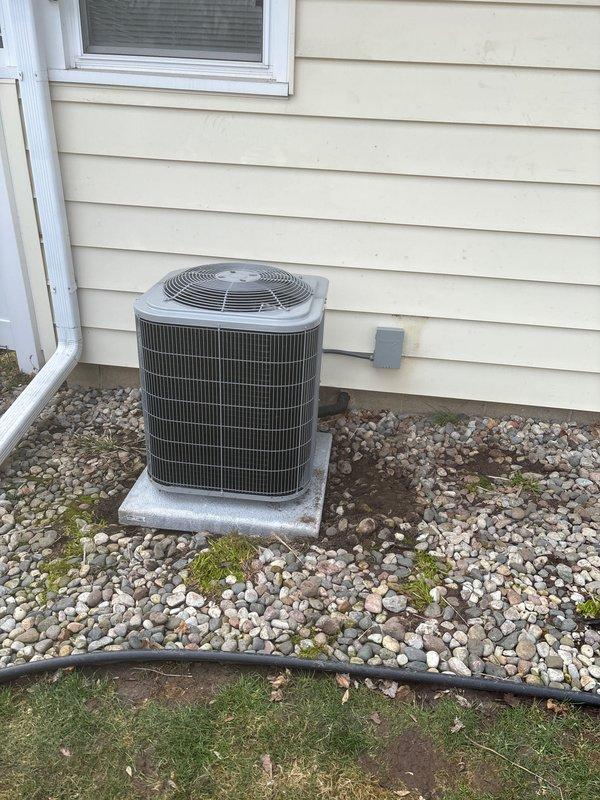 Completed full residential HVAC system replacement including installation of new Carrier furnace and outdoor AC condenser unit. Furnace installed on protective mat in utility area with proper PVC venting, electrical connections, and gas line hookup. Outdoor condenser positioned on concrete pad against exterior wall with electrical disconnect box mounted on siding. All service financing paperwork signed and finalized.