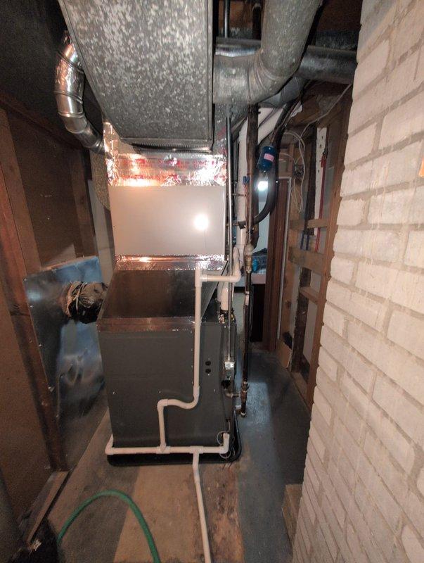 Completed full furnace replacement in confined basement mechanical room. Installed new furnace unit with corresponding ductwork connections, including flexible metallic ductwork with proper insulation wrapping. Connected all necessary PVC condensate drainage lines, verified proper placement of drain pan beneath equipment, and ensured all supply and return air duct transitions were properly sealed. System tested and operational upon completion.