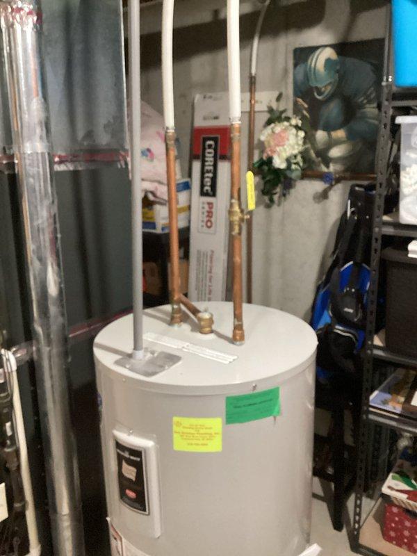 Responded to service call for 13-year-old Bradford White water heater experiencing premature hot water depletion. Unit was producing hot water but failing to maintain adequate supply duration. Upon inspection, documented existing installation and verified complaint of early cutout during hot water draw. Photographed unit specifications, labeling, plumbing connections, and control components for service records.