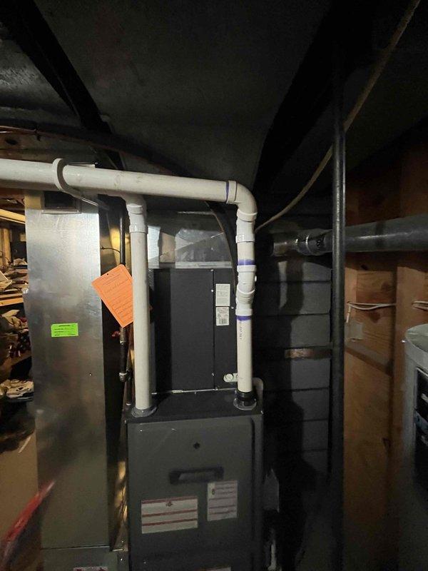 Completed annual heating maintenance on 13-year-old furnace and humidifier system in basement utility area. Performed comprehensive tune-up including inspection of heat exchanger, burner assembly, and combustion analysis; verified proper operation of all safety controls and limit switches; cleaned and adjusted burner components; checked and lubricated blower motor; replaced air filter; inspected and flushed humidifier system; tested thermostat operation and system cycling; verified proper venting through PVC exhaust system; confirmed all electrical connections secure; documented equipment condition with photos showing furnace, air handler, and associated ductwork in good operating condition with no immediate concerns noted.