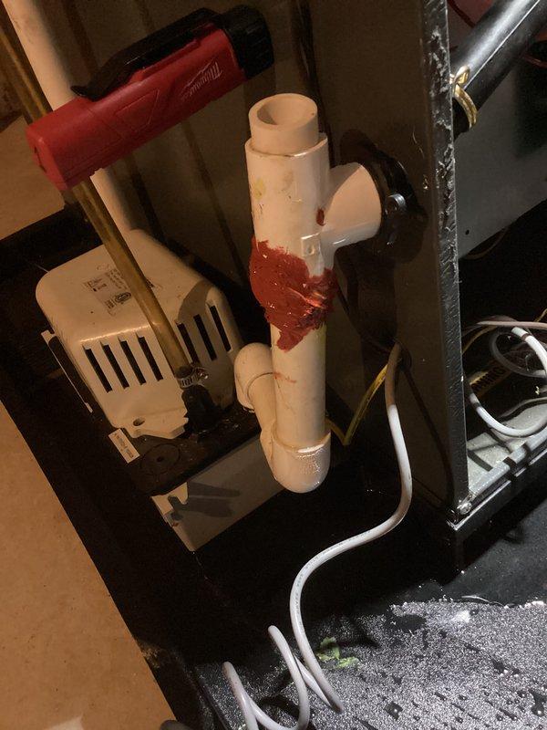 Responded to no heat call following previous day's tune-up. Upon inspection, discovered condensate drain system was clogged, preventing furnace operation due to safety switch activation. Cleared blockage from PVC condensate trap and drain lines, removed rust-colored buildup, verified proper drainage flow, and tested system to confirm furnace resumed normal heating operation to thermostat setpoint.