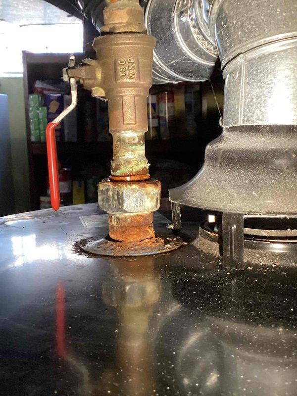 Completed annual heating maintenance on 17-year-old Carrier furnace and water heater tune-up per recurring service agreement. During inspection, discovered active water leak at water heater gas valve connection with significant corrosion, mineral buildup, and pooling water at base of valve assembly. Documented leak condition with photos showing compromised threaded brass connector and corroded flange with rust staining. Performed standard furnace maintenance procedures and notified customer of water heater leak requiring immediate attention to prevent further damage and potential safety concerns.