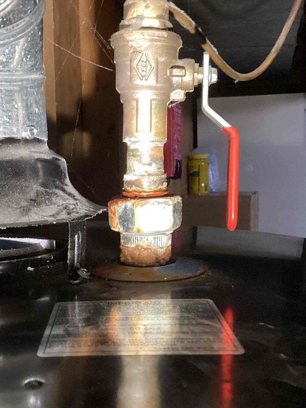 Completed annual heating maintenance on 17-year-old Carrier furnace and water heater tune-up per recurring service agreement. During inspection, discovered active water leak at water heater gas valve connection with significant corrosion, mineral buildup, and pooling water at base of valve assembly. Documented leak condition with photos showing compromised threaded brass connector and corroded flange with rust staining. Performed standard furnace maintenance procedures and notified customer of water heater leak requiring immediate attention to prevent further damage and potential safety concerns.