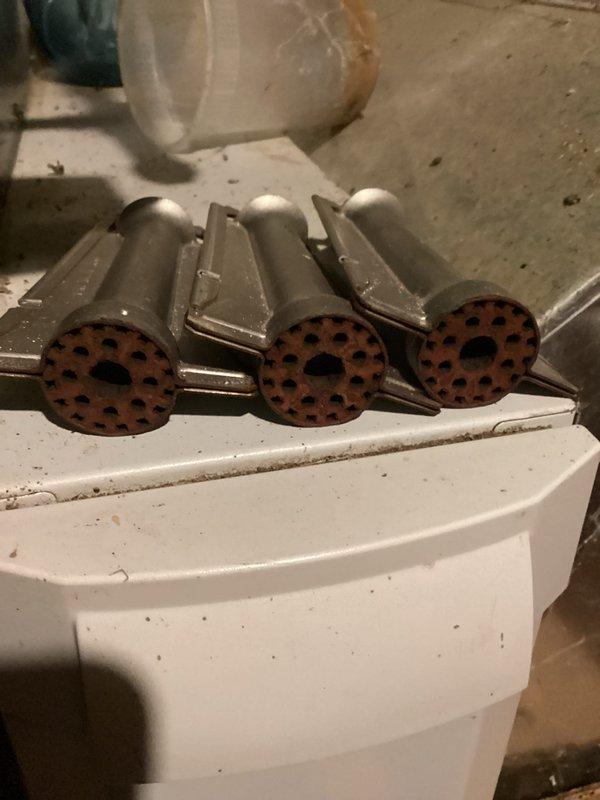 Completed annual heating maintenance on 12-year-old furnace system. Removed and inspected burner assemblies, finding surface oxidation on burner faces consistent with age and normal operation. Cleaned burners and blower motor assembly, verified proper operation of all components. System tested and returned to service with no humidity system present per customer preference.