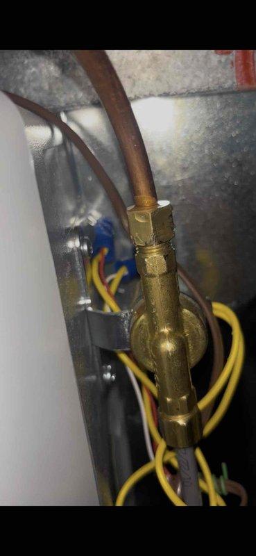 Responded to humidifier leak following recent installation. Upon inspection, identified water leakage at brass valve connection on copper supply line. Tightened threaded valve fitting and verified all connections were properly secured. Tested system operation and confirmed leak was resolved with no further water discharge observed.