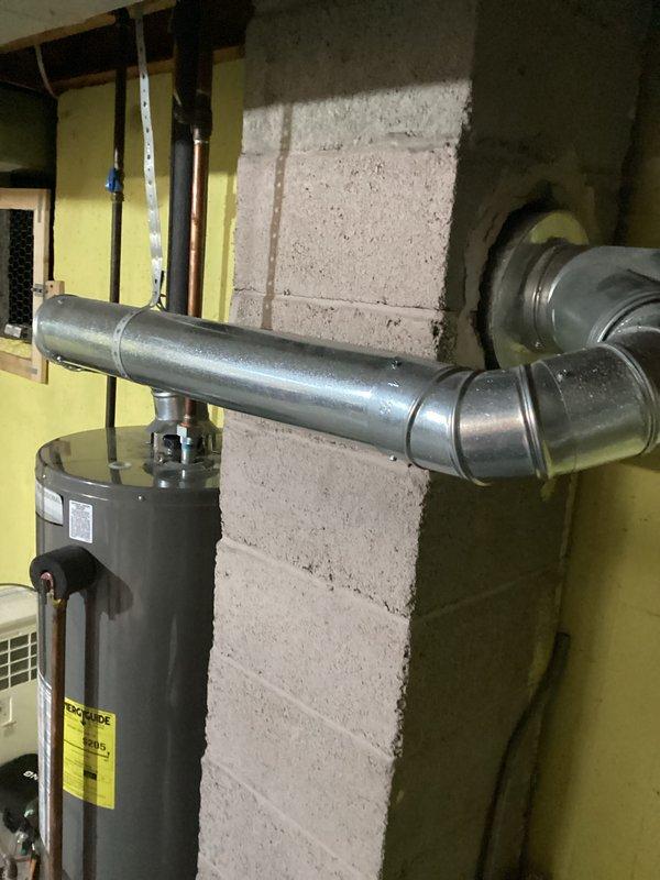 Responded to water leak concern involving 8-year-old Rheem 40-gallon natural gas water heater (Model PROH40S-3AN RH62, manufactured 07/2017) in 50-year-old home. Conducted thorough inspection of unit and surrounding area to identify source of water spreading across floor. Documented equipment condition, venting system, and installation configuration with photographs for diagnostic purposes and customer records.