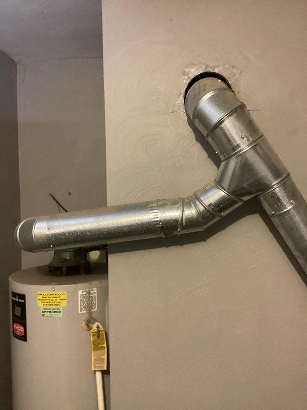 Provided estimate for water heater replacement in utility space with existing standard atmospheric vent water heater. Documented current installation including vent piping configuration and clearances. Reviewed replacement options and specifications with customer.