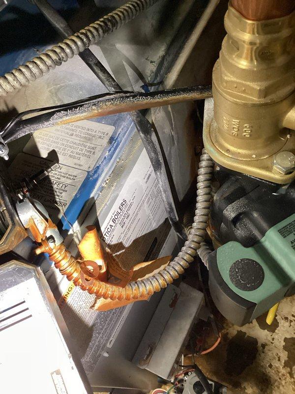 Responded to emergency service call for 4-year-old Utica WT 5-2031 boiler spraying water and failing to heat. Upon arrival, found extensive water damage on basement floor with significant moisture intrusion around boiler system and structural components. Inspected boiler unit, associated piping, valves, and mechanical connections. Identified source of water leak at brass valve assembly and compromised fittings. Examined control components, wiring, and flexible metal conduits for water damage and proper operation. Documented condition of equipment, extent of water damage to floor and surrounding area, and mechanical system configuration. Addressed immediate leak issue to prevent further water damage and restore heating functionality to the system.