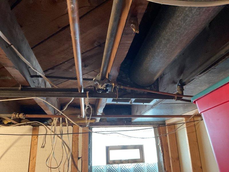Responded to gas leak at dryer hookup location where customer had already disconnected gas supply. Upon inspection of the basement utility area, assessed the copper gas line connection and confirmed that the existing hookup required replacement due to leak at connection point. Documented the condition of the gas piping system and surrounding mechanical infrastructure with photographic evidence for service records.